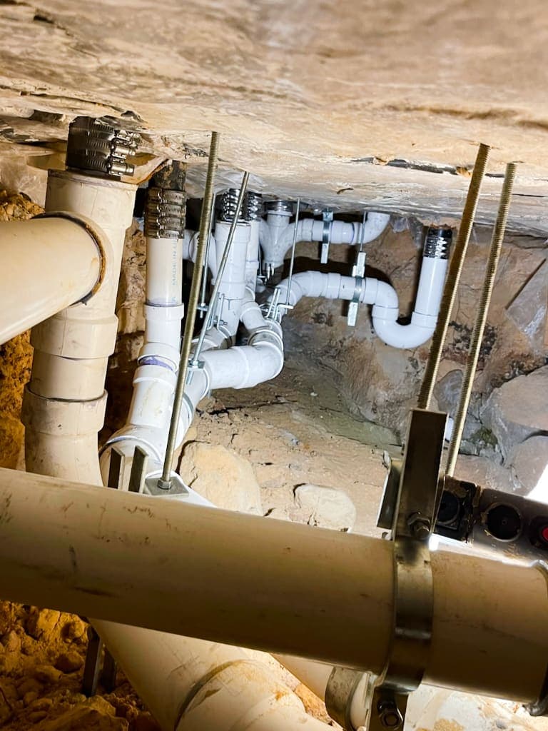 New plumbing lines anchored beneath a concrete slab foundation
