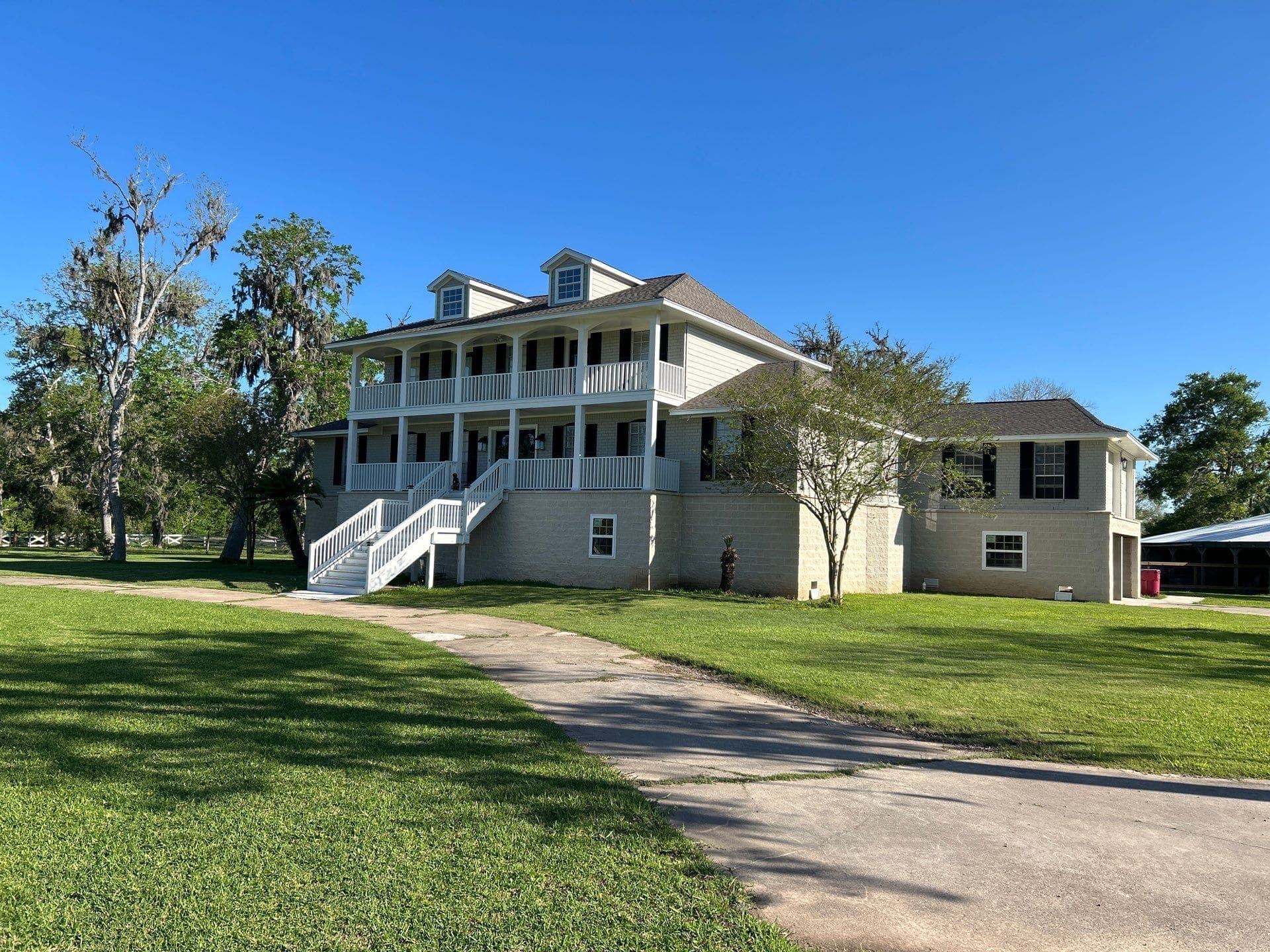 The same white house raised on its new elevation with a white staircase