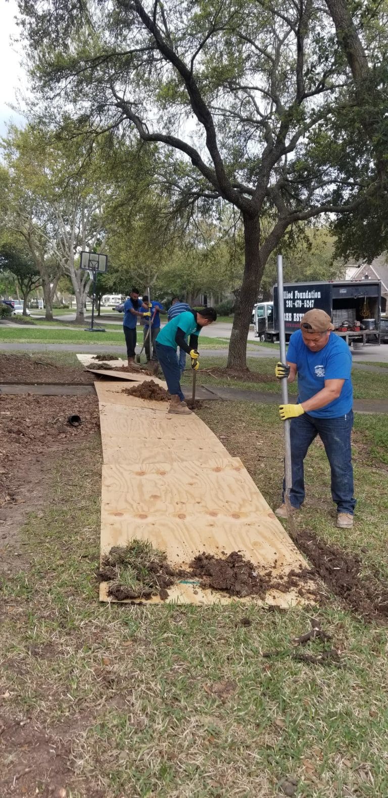 a group of people working in a yard