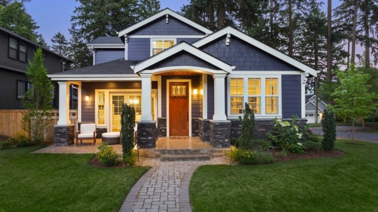 a blue house with white trim and yellow windows