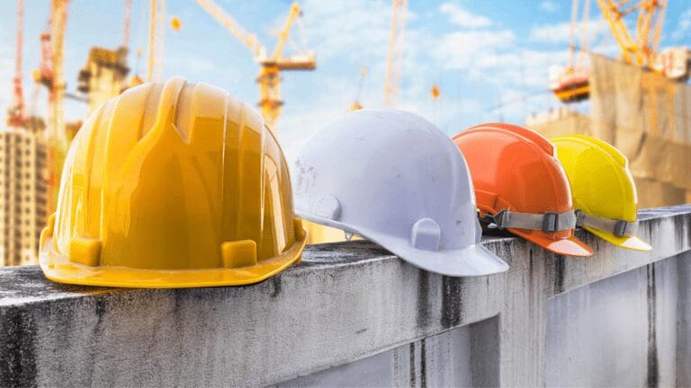 three hard hats are lined up on a wall