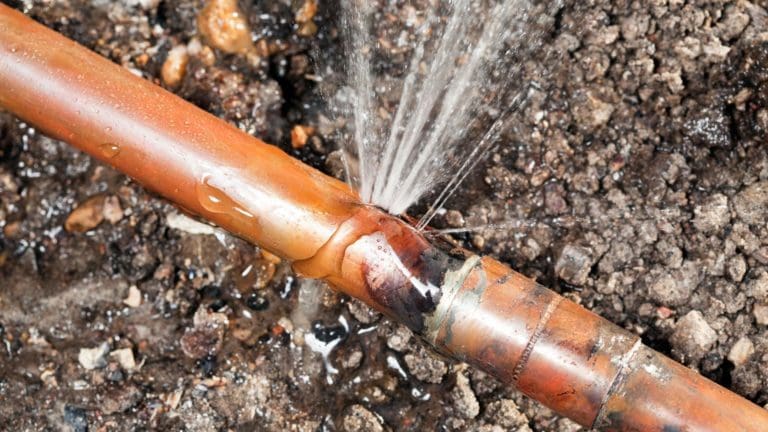 a fire hydrant spewing water onto the ground