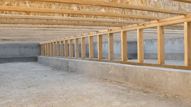 an unfinished room with wooden beams and walls