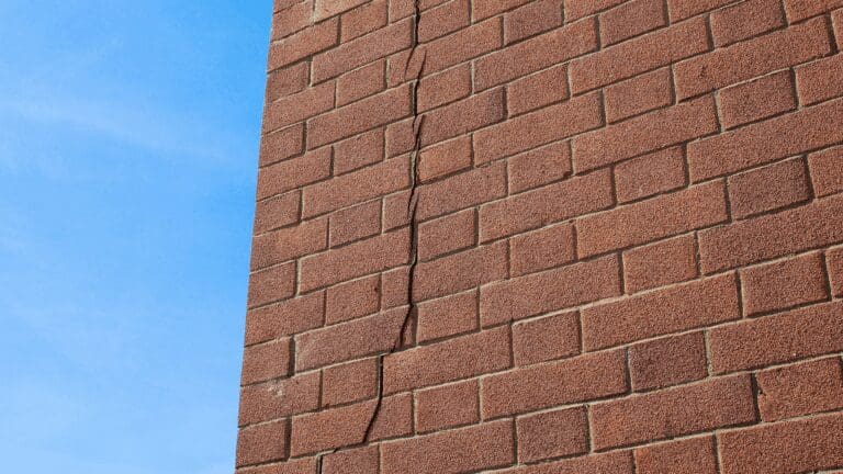 a clock on the side of a brick building