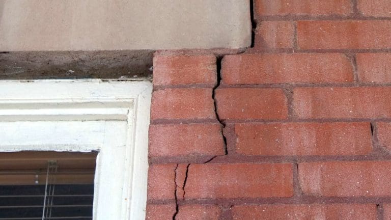 a red brick building with a broken window