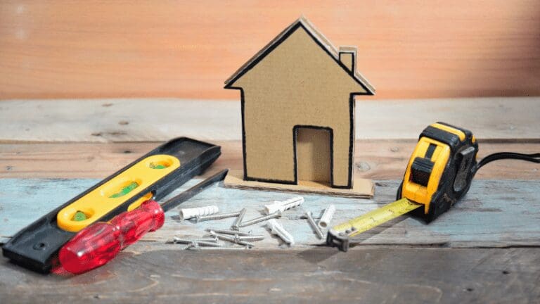 a house and tools on a wooden table