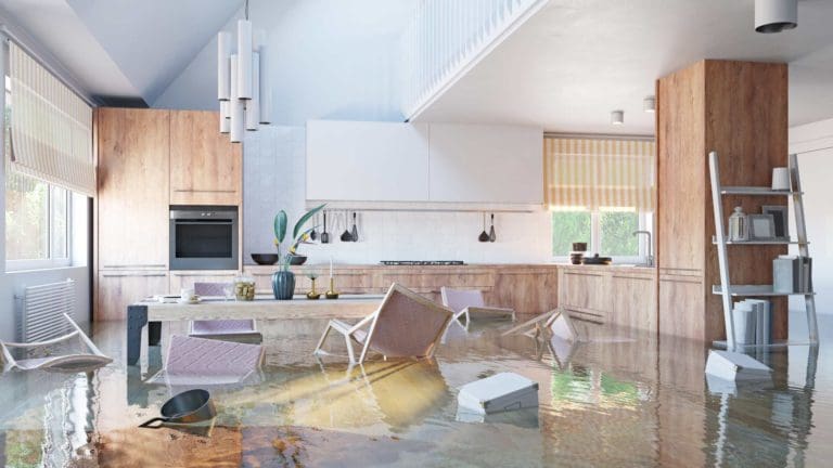 a flooded kitchen and dining room with chairs