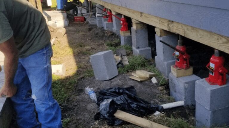 a man standing next to a pile of cement blocks