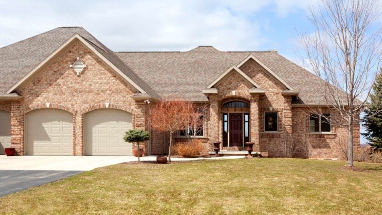 a large brick house with two garages