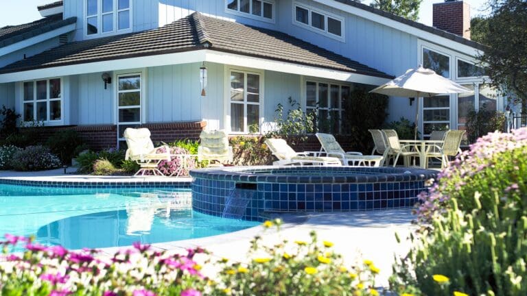 a house with a swimming pool in front of it