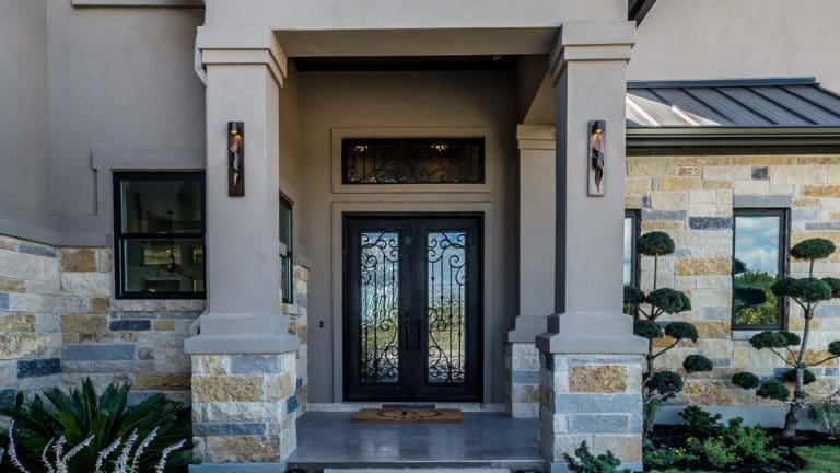 the front door of a house with a glass paneled entry