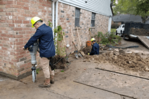 two men repairing home foundation