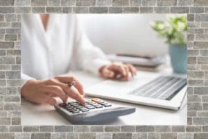 woman working on calculator and laptop for an estimate
